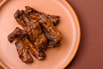 Grilled beef or pork ribs, meat cooked on a barbecue with salt and pepper. Grilled ribs