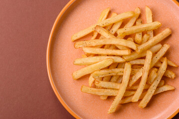 Crispy French fries with sauce, fast food, snack or chips. French fries, takeaway food