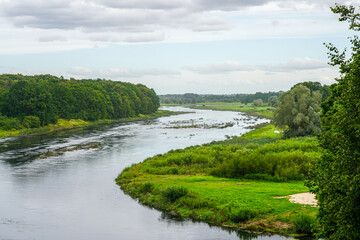 Obraz premium Scenic view of Lielupe River from Mezotne Castle Mound in Latvia with lush green landscape