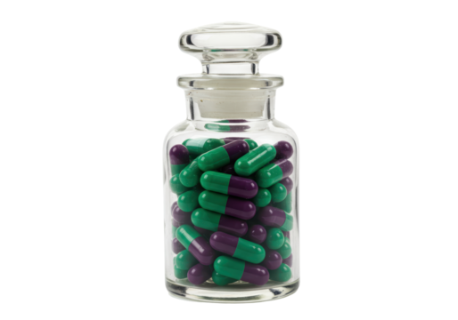 Isolated jar of medical capsules, purple and green, glass container with lid filled to top