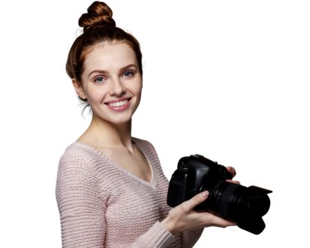 Young woman smiling while holding a camera in a photography studio