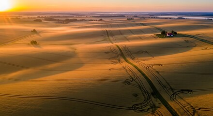 Sunrise over rural farmland fields.