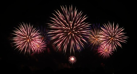 Fireworks display against a black sky explosions celebration festive nighttime background
