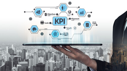 A business professional showcases a digital tablet with KPI metrics above a modern city skyline. This image symbolizes performance measurement and strategic planning. Tessel