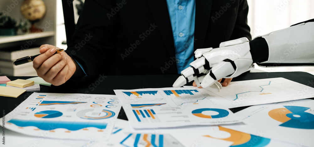 Poster a business professional engages in data analysis using a robotic hand, showcasing various charts and