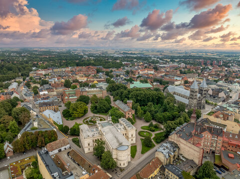 Aerial view of the medieval old town center of Lund in Sweden with University main building, Romanesque Cathedral dramatic sunset sky