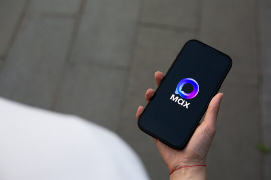 Moscow, Russia, August 14, 2025: Logo of Russian messenger Max on black background with inscription. The name and sign of social network Max on phone in the hand of smartphone user