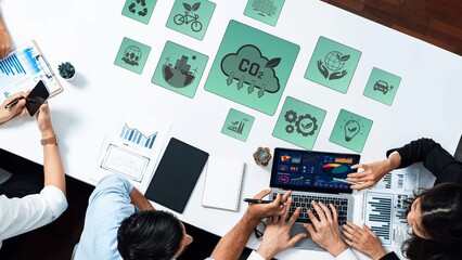 A top view capture of a business meeting focusing on environmental sustainability, featuring charts, graphs, and eco-friendly icons to promote discussion and strategy. Raster