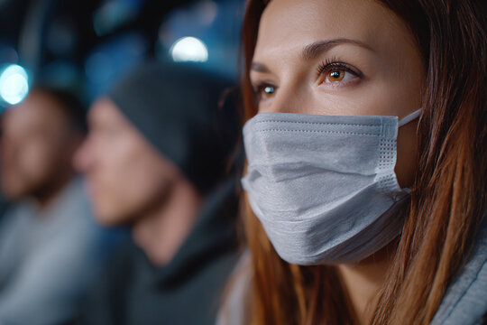 young woman in mask in public transport