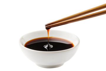 Chopsticks dipping into soy sauce in a white bowl isolated on transparent background. Delicious dumpling held with chopsticks dripping soy sauce isolated on white background.