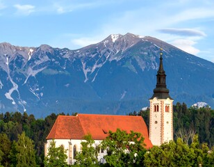 Fototapeta premium Picturesque church nestled in valley, mountains in background
