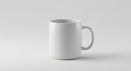 Fototapeta premium A simple white ceramic mug with a handle on a plain white background in a studio shot setting here now