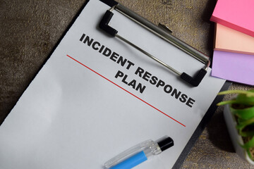 Concept of incident response plan write on clipboard isolated on Wooden Table. © syahrir
