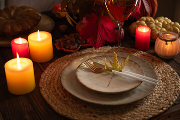Autumn Table Setting with Plates, Wine, Pumpkins and Seasonal Decor