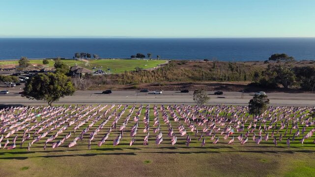 Plenty of national symbols in memory of citizens lost in the terror attack as seen from above. Drone shot of Waves of Flags display along Pacific Coast Highway in Malibu. High quality 4k footage