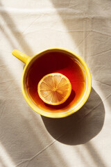 Flat Lay with Lemon Tea on Light Table under Sun Light