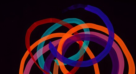 Abstract art featuring overlapping colorful curved lines on a stark black background design element
