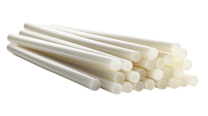 Stack of cylindrical, off-white plastic rods.  Close-up view.  Uniform size and shape.  Likely adhesive or crafting supplies