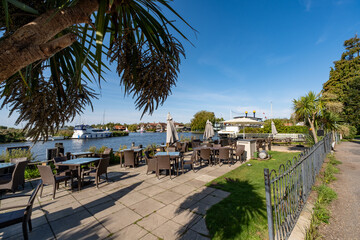 Fototapeta premium Beer garden on the bank of the River Bure in Horning, Norfolk Broads