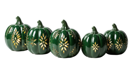 Five glossy deep forest green ceramic pumpkins emitting light through laser-cut nature patterns, on a transparent background with copy space, elegant autumnal decor concept