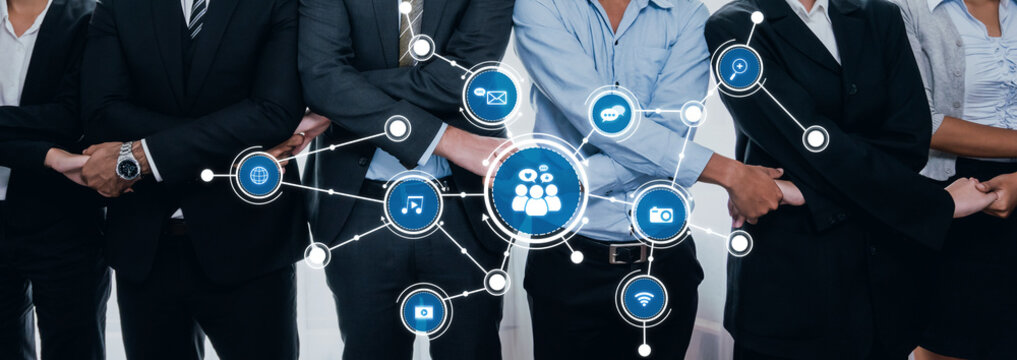 A diverse group of professionals in business attire demonstrating teamwork and innovation. They are integrated with digital networks, symbolizing modern collaboration and connectivity. Amity