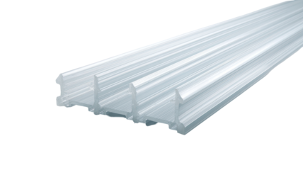 Close-up of a translucent, architectural trim piece, featuring a ribbed, channelled design.  The material appears rigid and smooth