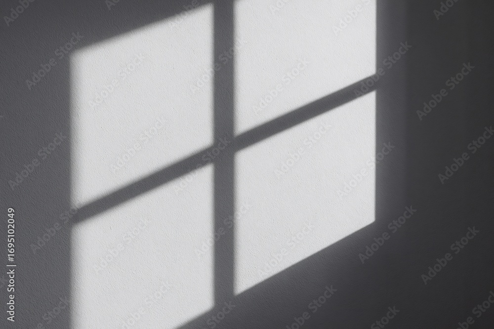 Poster window frame casting shadows on a textured white wall, creating an abstract geometric pattern of lig