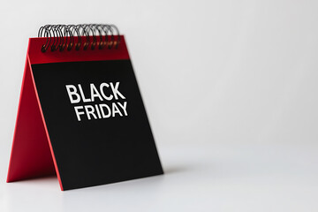 A black calendar with white text displays 