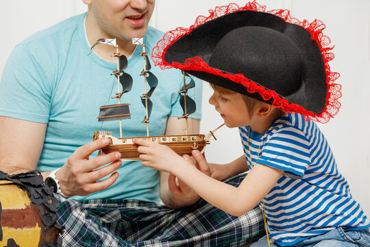Playful pirate adventure bonding with dad and son in costumes