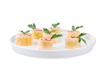 Omelette egg roll with imitation crab meat filling, tamagoyaki, in a plate on a white isolated background