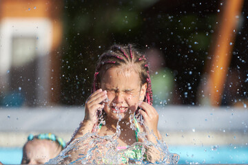 Young girl enjoys splashing in water