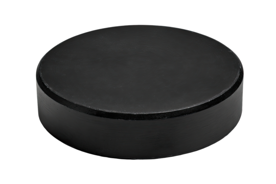 Black hockey puck isolated on black background, studio shot, for sports product
