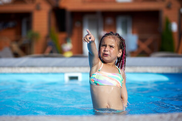 Little girl enjoys summer fun in the pool