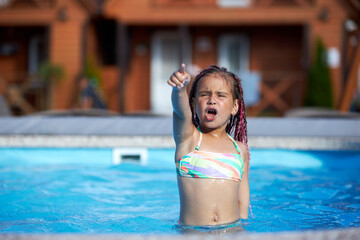 Young girl enjoys water play at a pool