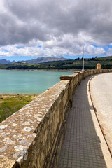 Los Bermejales Reservoir is a tranquil body of water surrounded by scenic natural landscapes and pine forests in the province of Granada, Spain