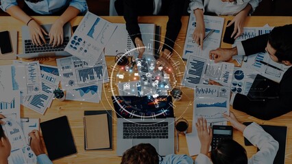 A dynamic business team engages in a collaborative strategy meeting, analyzing data and utilizing digital tools to drive innovative solutions and foster growth. Raster