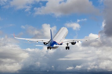 Airplane flying in blue sky, travel background