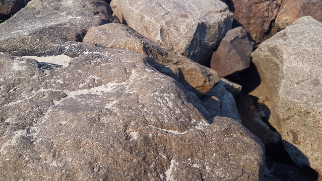 Riprap stones installed along the beach form a dike to hold back ocean waves.