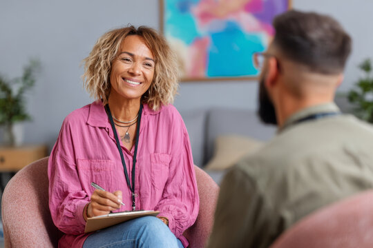 Close-up of smiling Black female therapist during warm and professional consultation - Powered by Adobe
