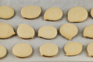 Homemade cookies topped with meringue frosting, freshly baked on a white background with copy space