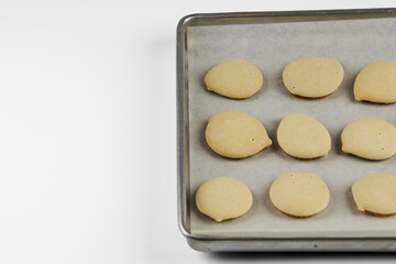 Homemade cookies topped with meringue frosting, freshly baked on a white background with copy space