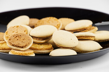 Homemade cookies topped with meringue frosting, freshly baked on a white background with copy space