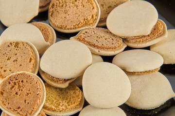 Homemade cookies topped with meringue frosting, freshly baked on a white background with copy space