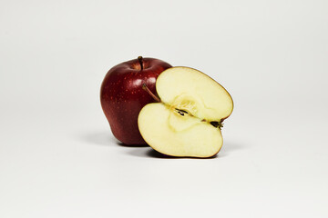 Red apple isolated on a table in close-up with copy space under a white background
