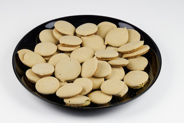 Homemade cookies topped with meringue frosting, freshly baked on a white background with copy space