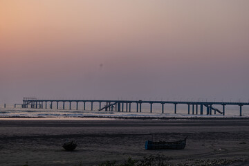Romantic evening coastal walk framed by glowing sunlight and rhythmic sea waves.