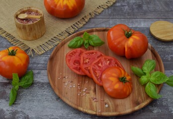 Fresh, juicy sliced ​​tomato with basil and Himalayan salt