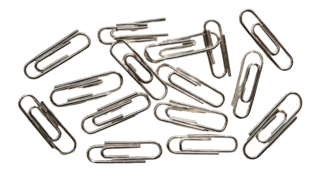 Scattered metal paperclips, a cluster of many, overlapping