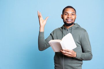 Young adult narrating a literature book aloud for entertainment, cheerful person with a lecture...