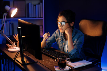 Stressful young beautiful asian creative looking on pc to search project creator social media...